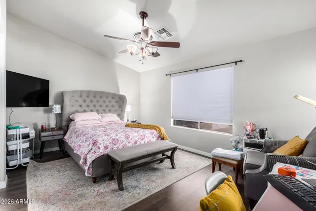 a bedroom with a bed and flat screen tv