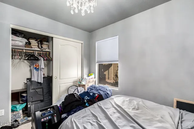 a bedroom with a bed and a chandelier