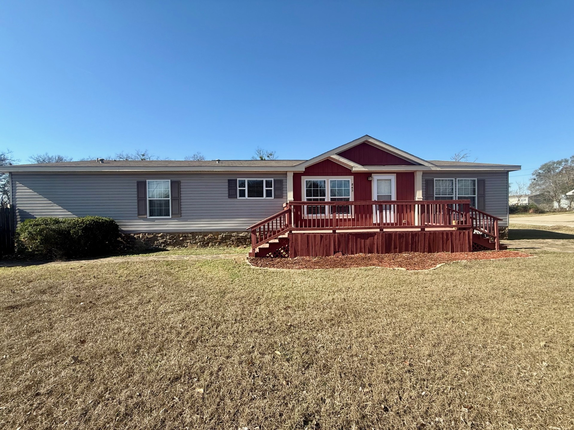 845 Caldwell Street Lexington, TX 78947 - Photo 35 of 39 View of front of home with a front yard and a wooden deck