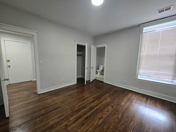 a view of a room with wooden floors and stairs