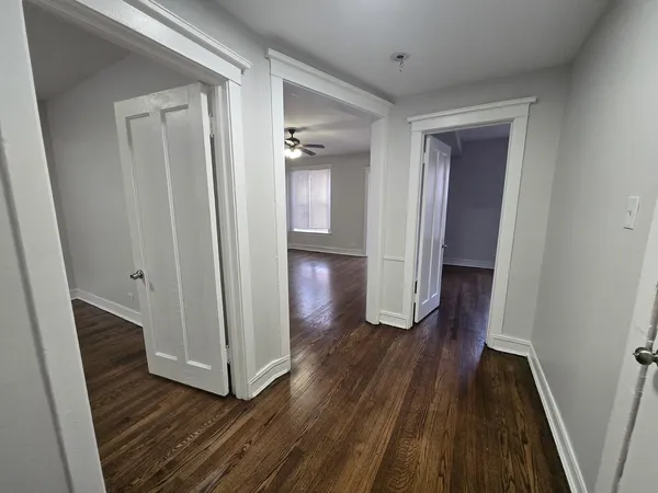 a view of a hallway with wooden floor