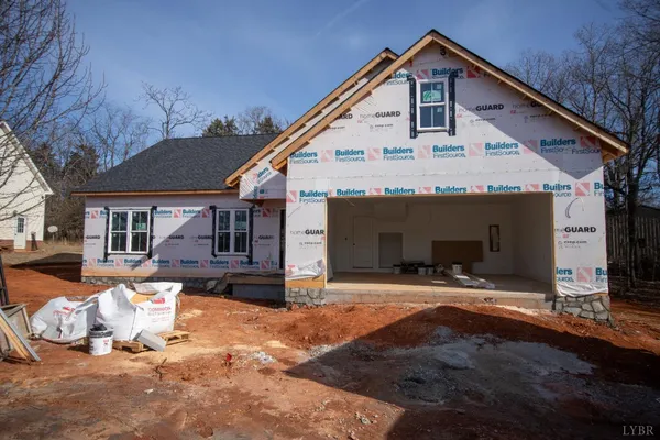 a front view of a house with yard outdoor seating and garage