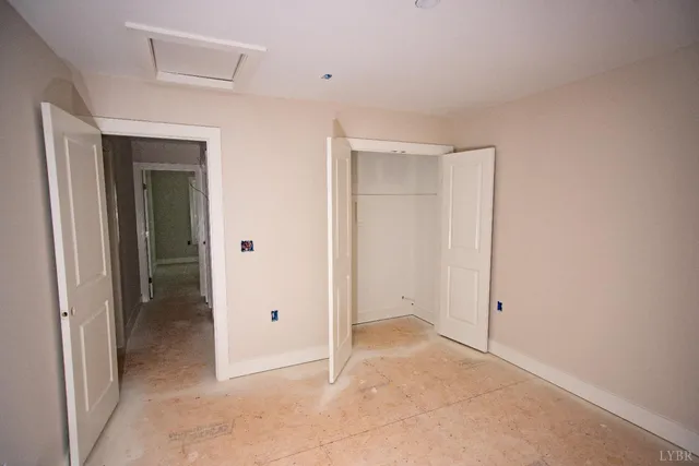 an empty room with closet area