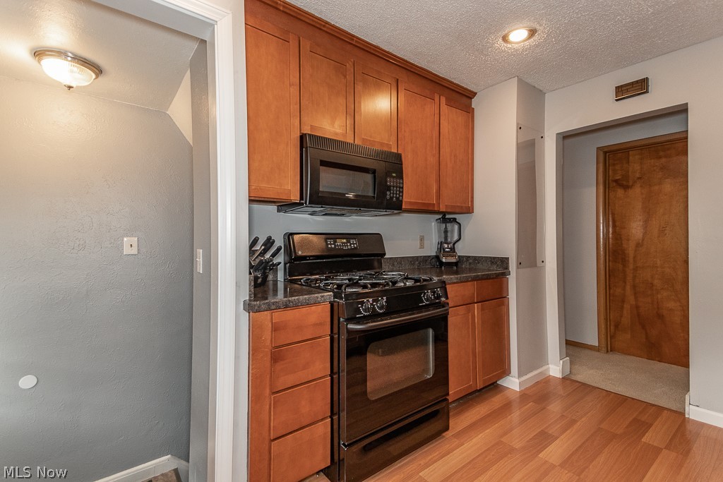 697 Glenhurst Road Willowick, OH 44095 - Photo 7 of 27 Kitchen leads to hall to bedrooms