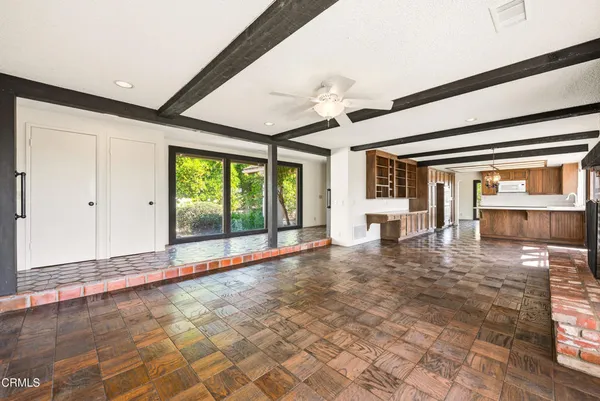 a view of an empty room with a fireplace and a window