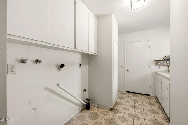 a view of a kitchen with white cabinets