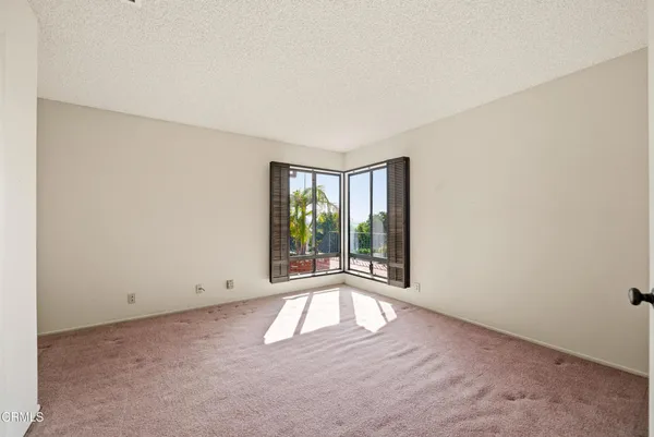 a view of a room that has a bed and a window