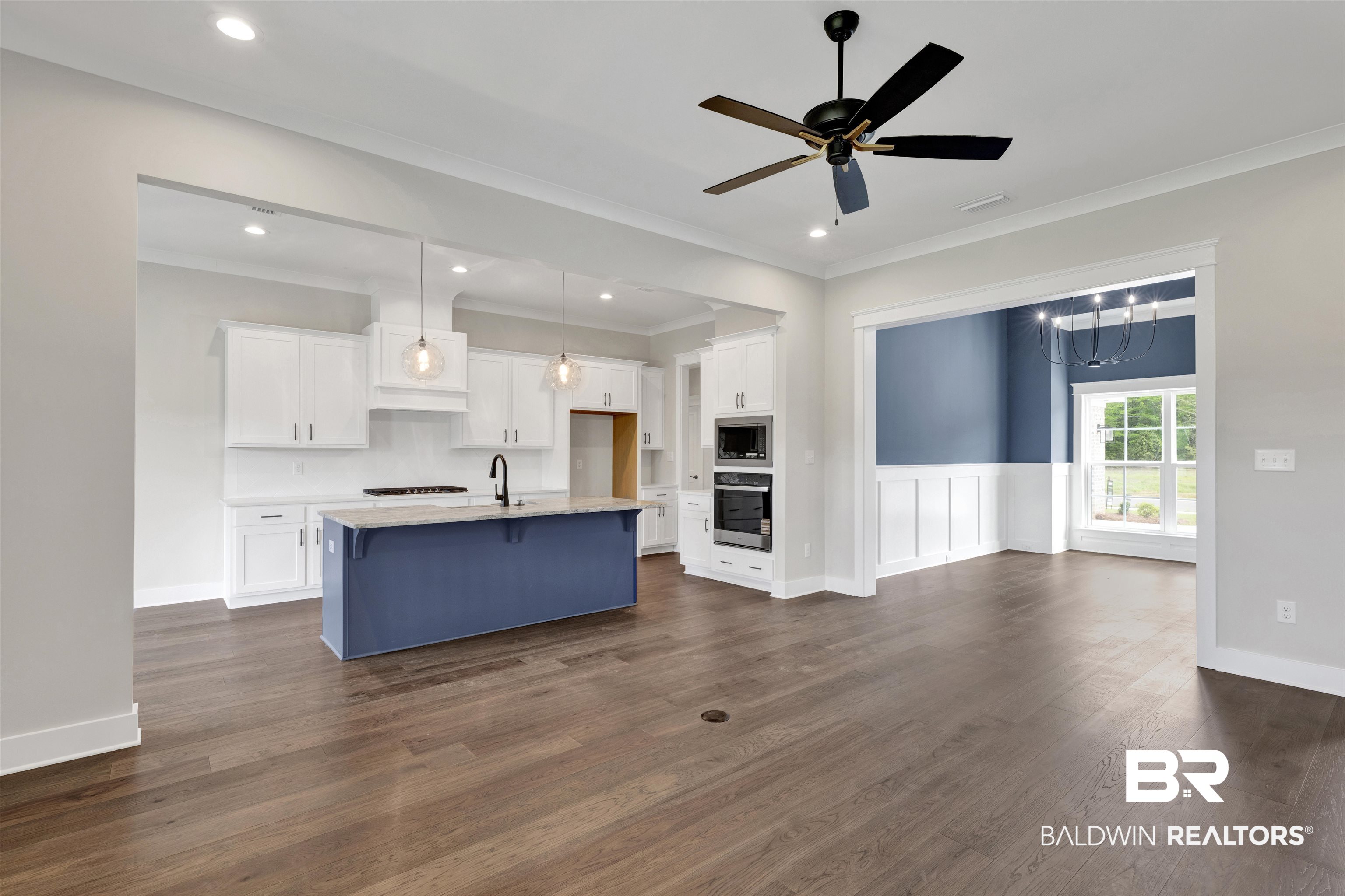 27315 Patch Pl Loop Daphne, AL 36526 - Photo 42 of 43 Dual tone kitchen with ceiling fan, open floor plan, wood flooring, an island with sink, and stainless steel appliances