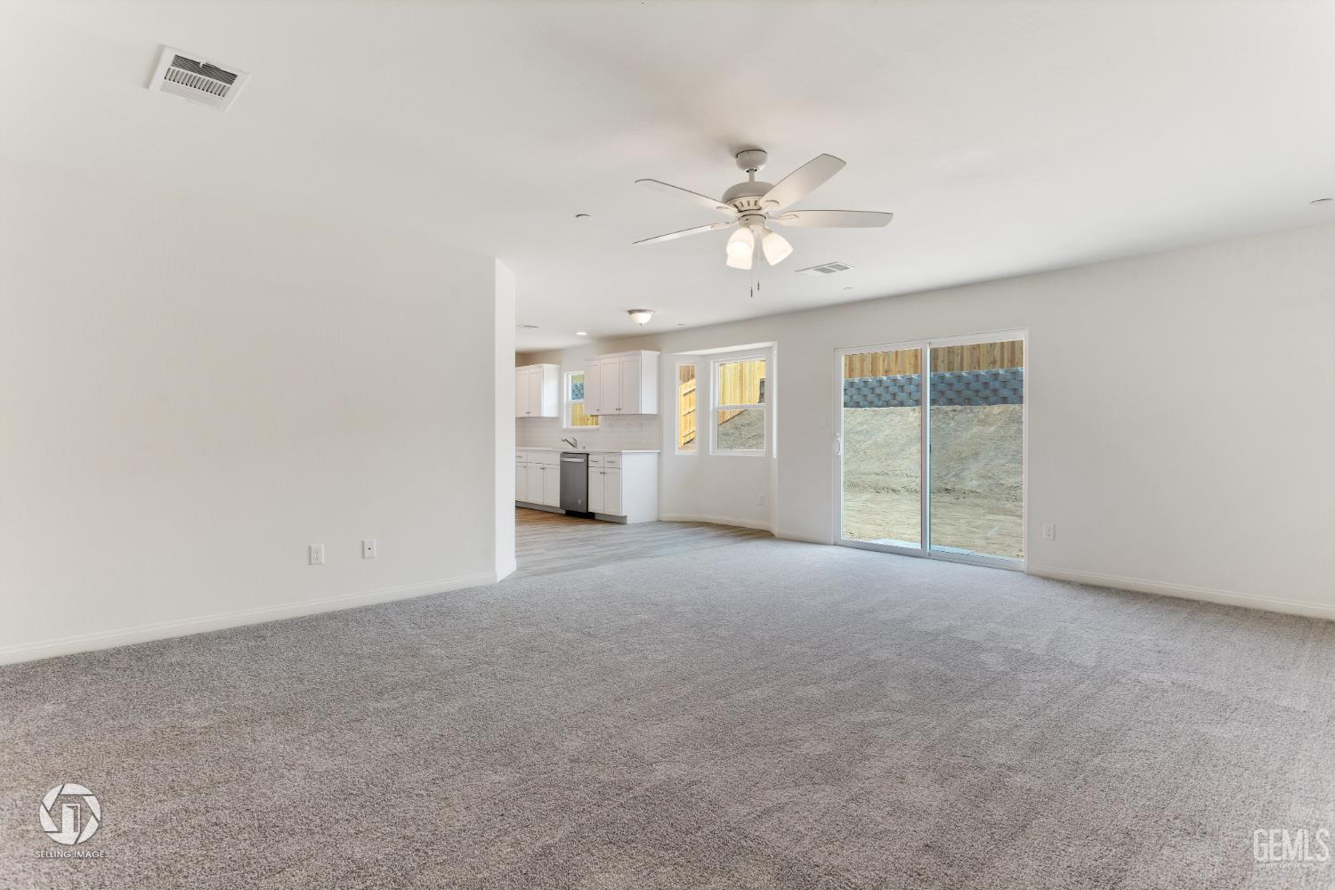 Undisclosed Address Shafter, CA 93263 - Photo 11 of 27 a view of a big room with windows and chandelier fan