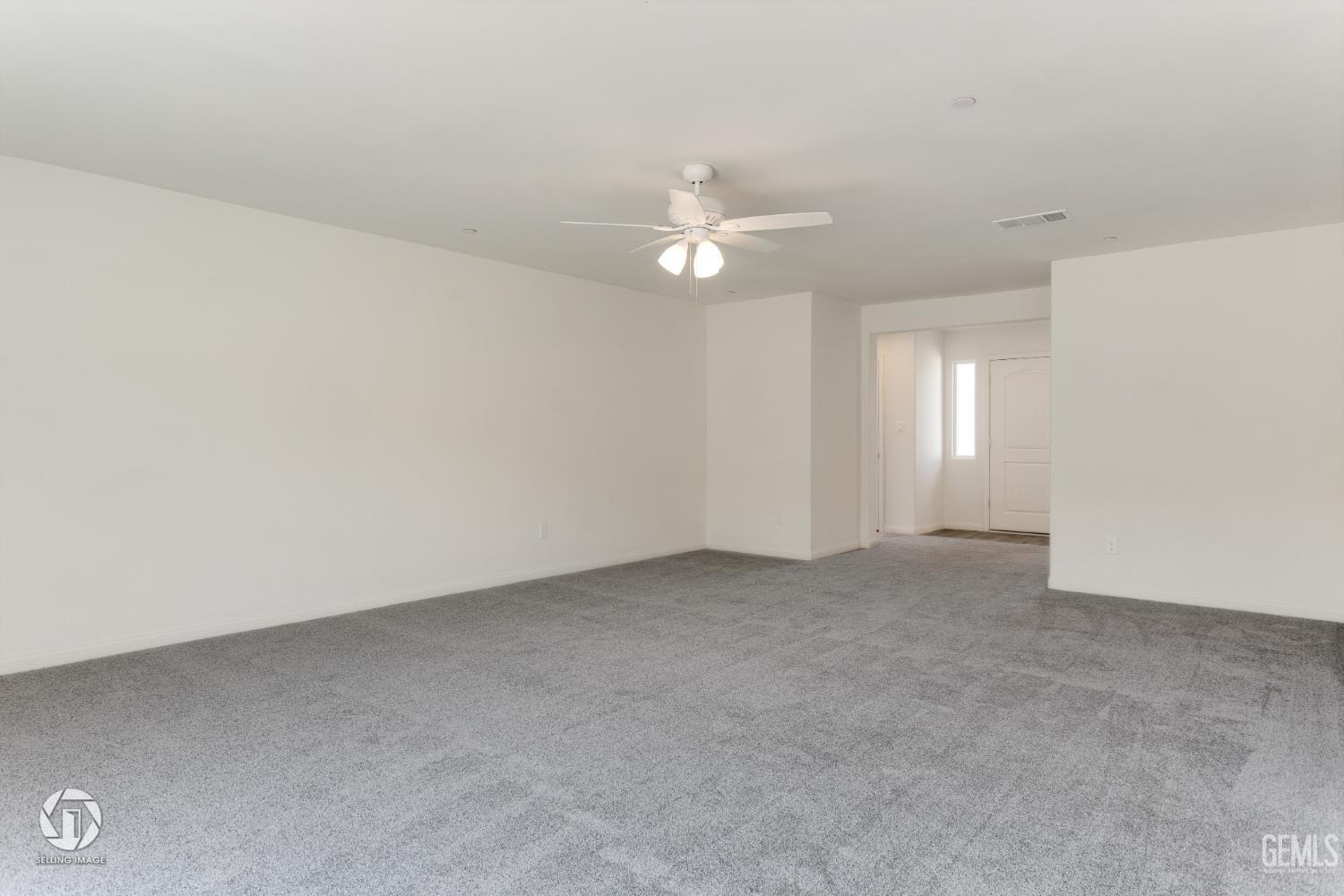 Undisclosed Address Shafter, CA 93263 - Photo 23 of 27 an empty room with chandelier fan and windows