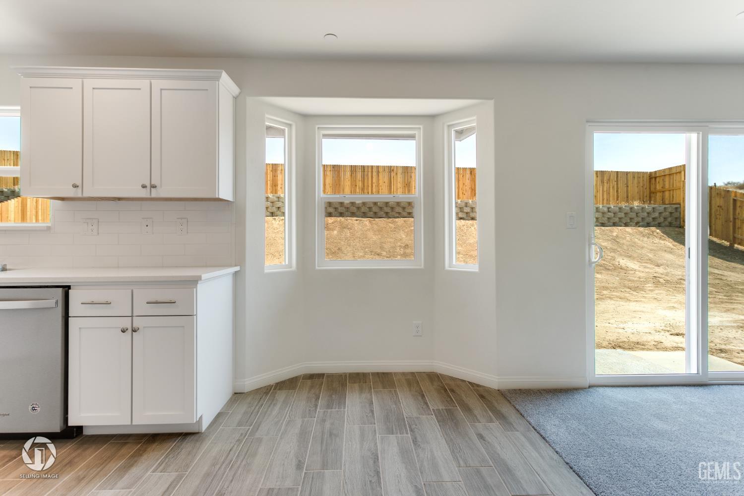 Undisclosed Address Shafter, CA 93263 - Photo 8 of 27 a view of an empty room with a window and wooden floor