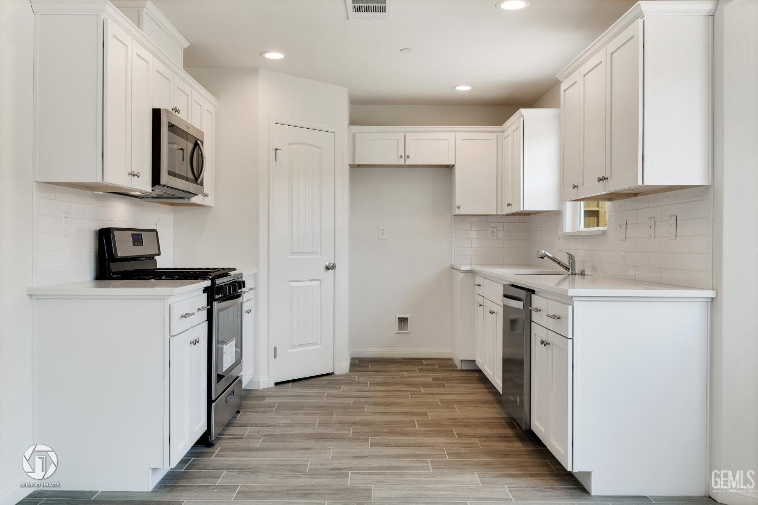 Undisclosed Address Shafter, CA 93263 - Photo 9 of 27 a kitchen with stainless steel appliances granite countertop a refrigerator sink and white cabinets