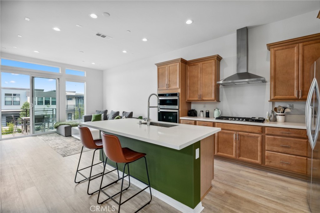 160 Keeper Irvine, CA 92618 - Photo 1 of 29 a kitchen with stainless steel appliances granite countertop a stove top oven a sink dishwasher and white cabinets with wooden floor