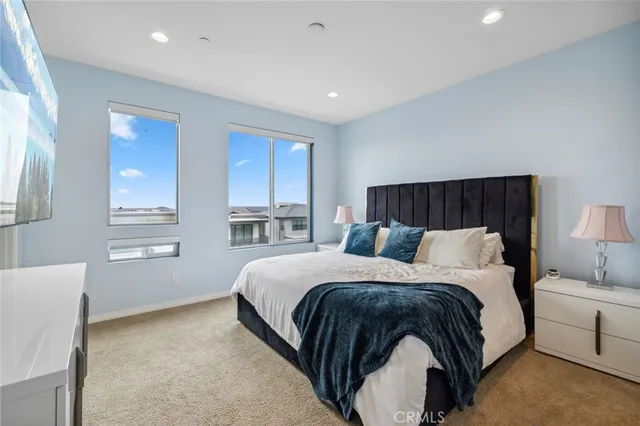 a bedroom with a bed and a flat screen television