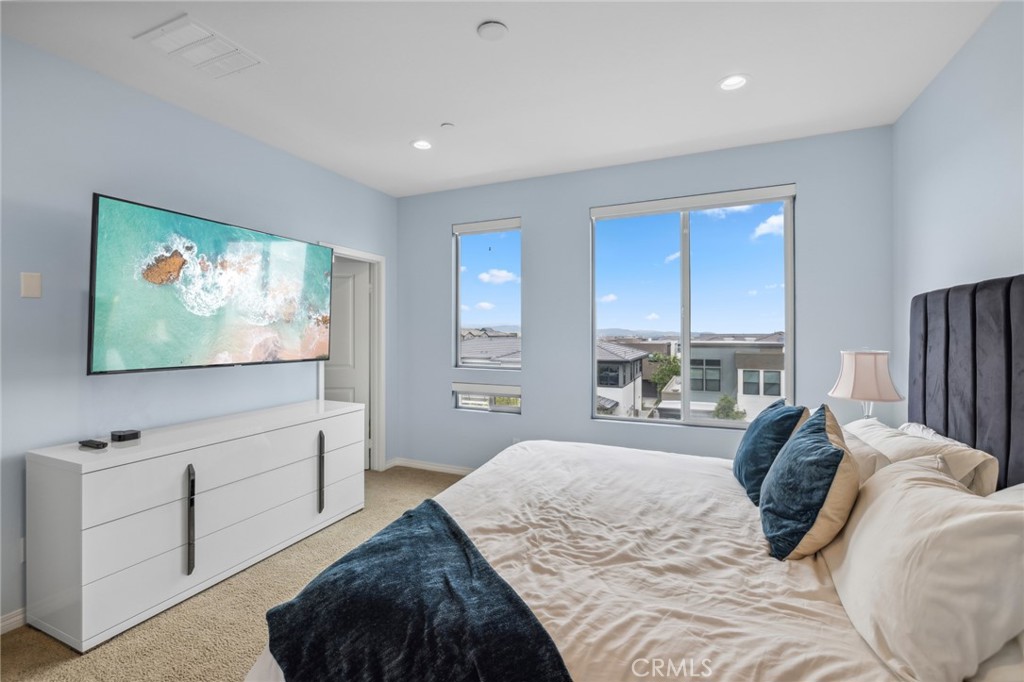 160 Keeper Irvine, CA 92618 - Photo 13 of 29 a bedroom with a bed and a flat screen television