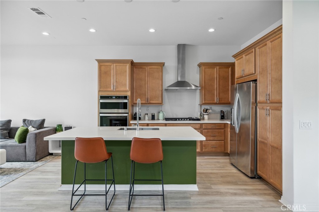 160 Keeper Irvine, CA 92618 - Photo 4 of 29 a large kitchen with kitchen island granite countertop a stove a sink a dining table and chairs