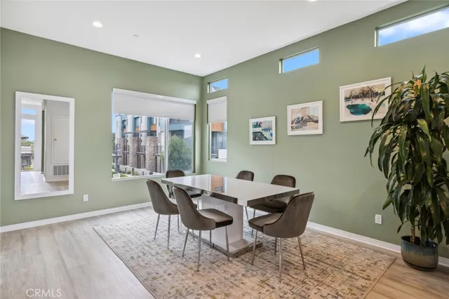 a kitchen with a table chairs refrigerator and stove