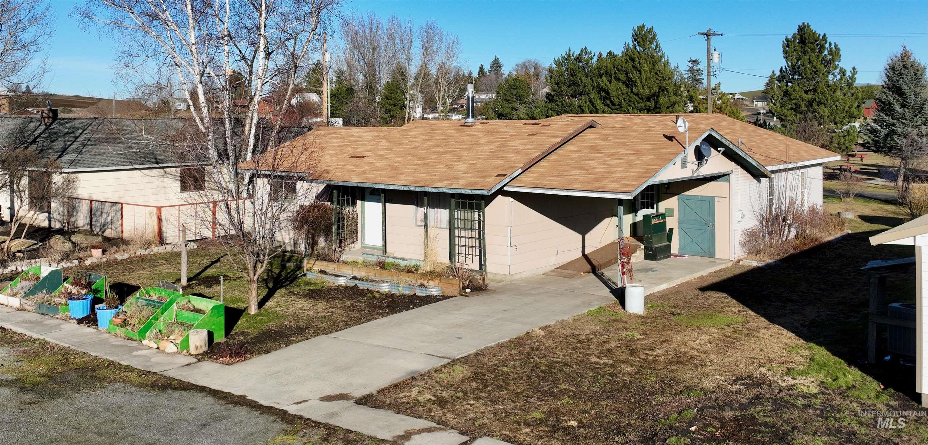 Single story home featuring roof with shingles