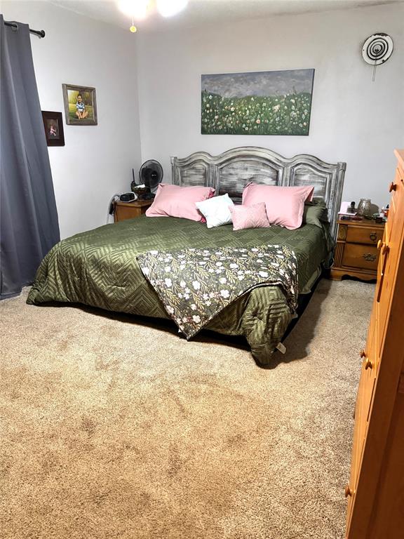 705 Loop Road Quanah, TX 79252 - Photo 14 of 14 a bedroom with a bed and a couch