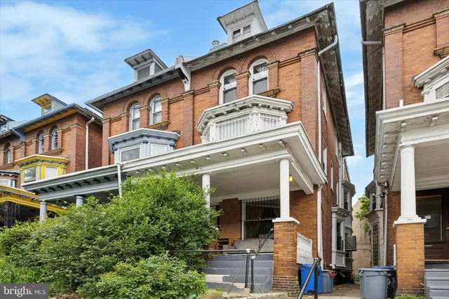 a front view of a residential houses with yard