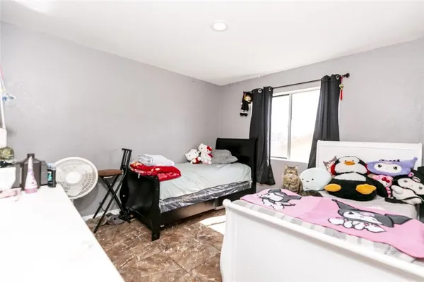a bedroom with bed and a window