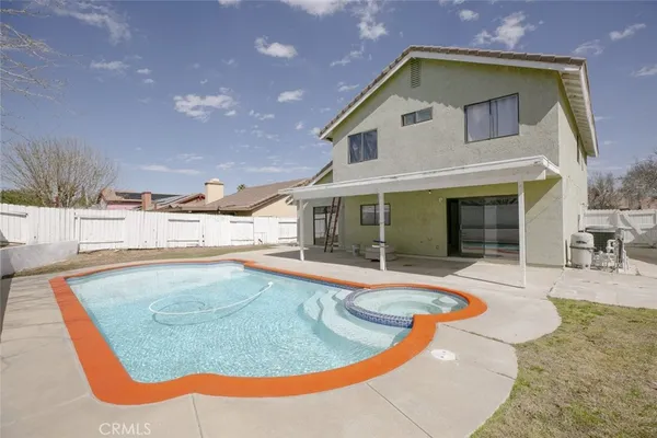 a view of a house with swimming pool and sitting area