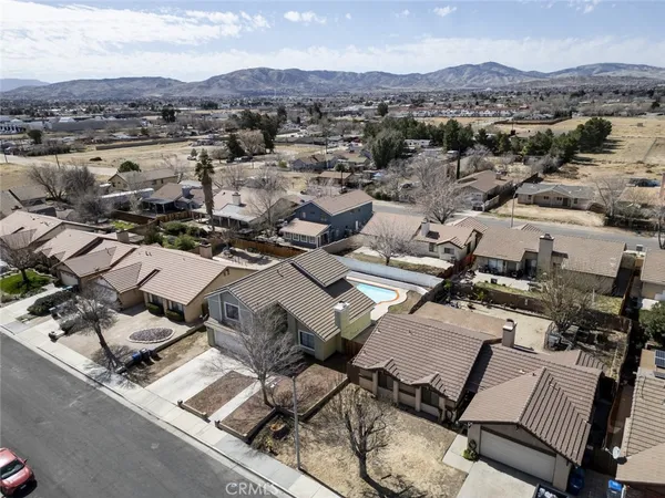 an aerial view of a houses with a city street
