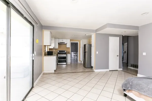 a view of a kitchen with furniture and an empty room