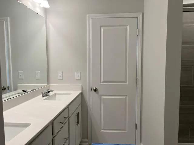 a bathroom with a sink vanity and a mirror