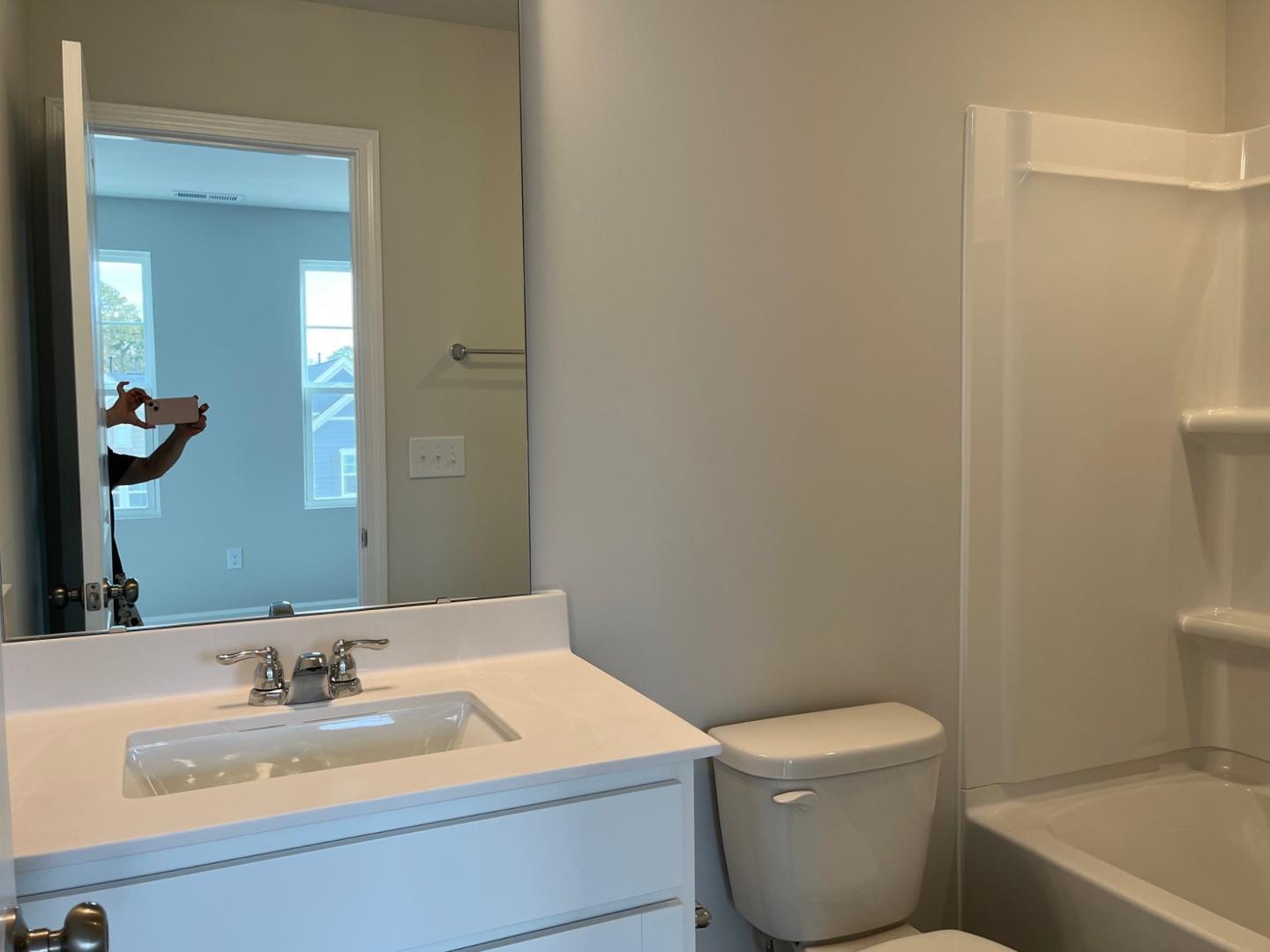 1705 Barrett Run Trail Apex, NC 27502 - Photo 15 of 24 a bathroom with a sink a toilet and shower