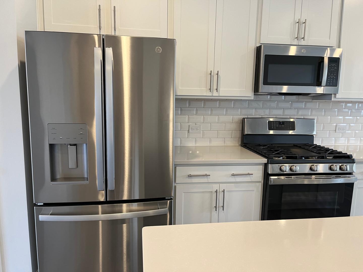 1705 Barrett Run Trail Apex, NC 27502 - Photo 6 of 24 a kitchen with stainless steel appliances granite countertop a refrigerator a stove top oven a sink and dishwasher
