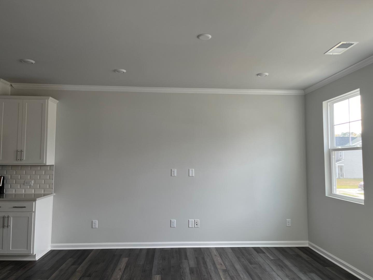 1705 Barrett Run Trail Apex, NC 27502 - Photo 9 of 24 a view of an empty room with wooden floor and a window