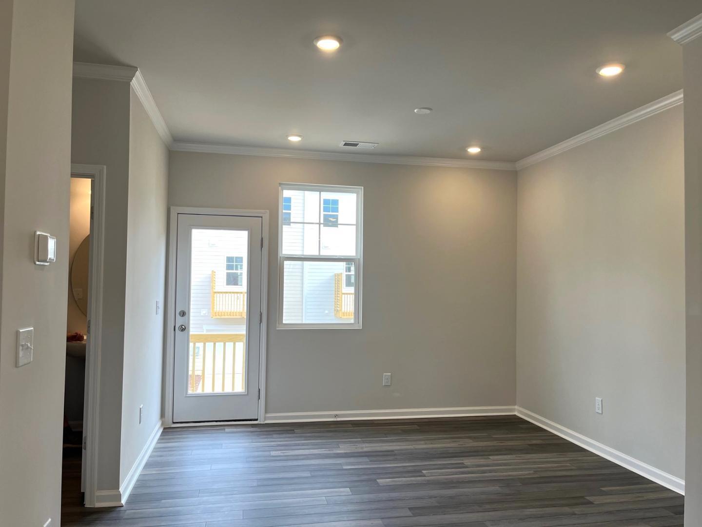 1705 Barrett Run Trail Apex, NC 27502 - Photo 10 of 24 a view of an empty room with wooden floor and a window