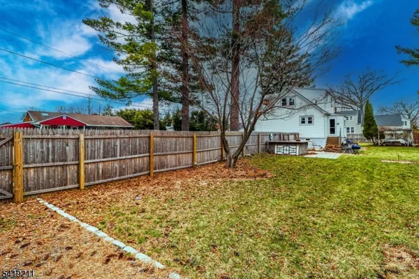 a view of backyard with wooden fence
