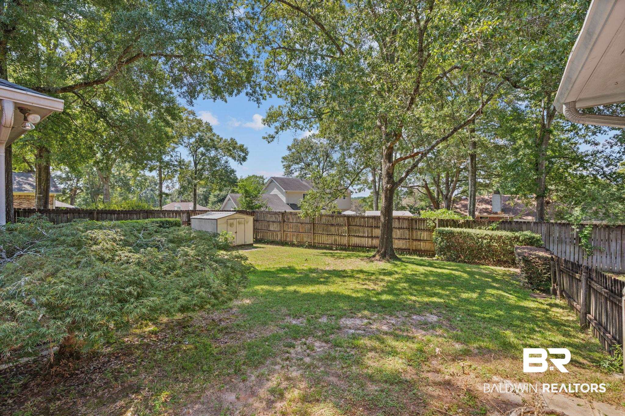 1340 Wellsley Court Mobile, AL 36695 - Photo 10 of 37 Fenced backyard with a storage unit