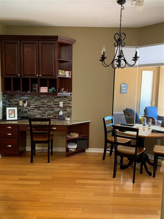 6828 Honeysuckle Trail Lakewood Ranch, FL 34202 - Photo 14 of 36 a view of a dining room with furniture