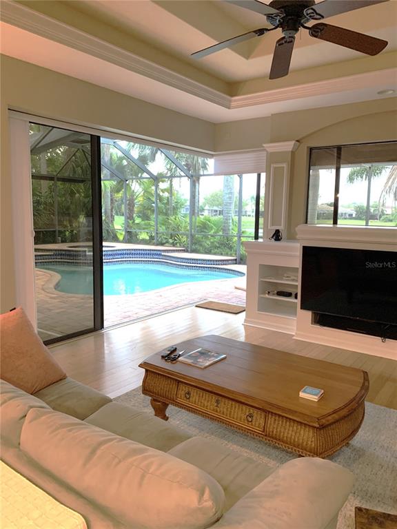 6828 Honeysuckle Trail Lakewood Ranch, FL 34202 - Photo 18 of 36 a living room with couch and a fireplace
