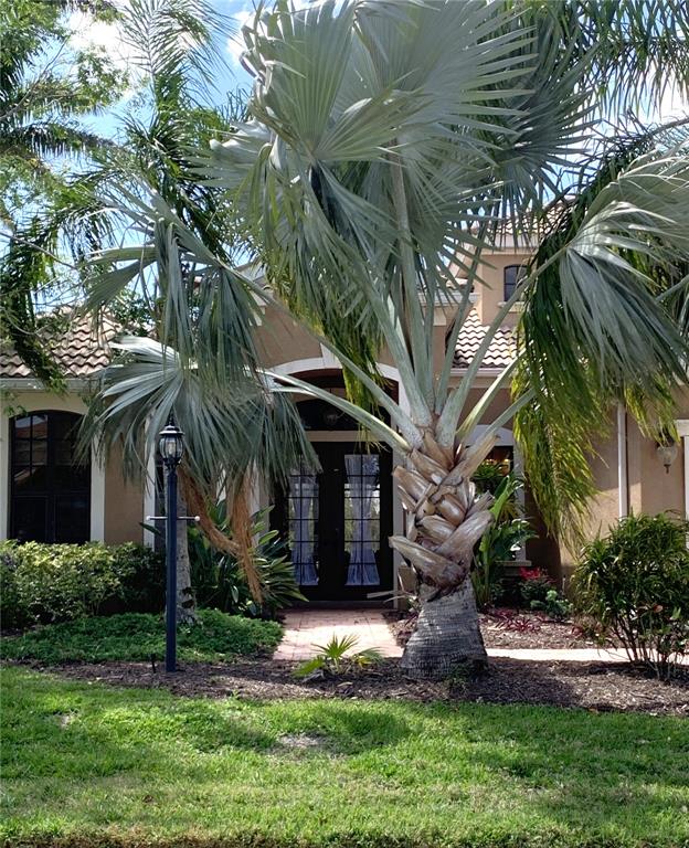 6828 Honeysuckle Trail Lakewood Ranch, FL 34202 - Photo 2 of 36 a view of a house with a yard and plants