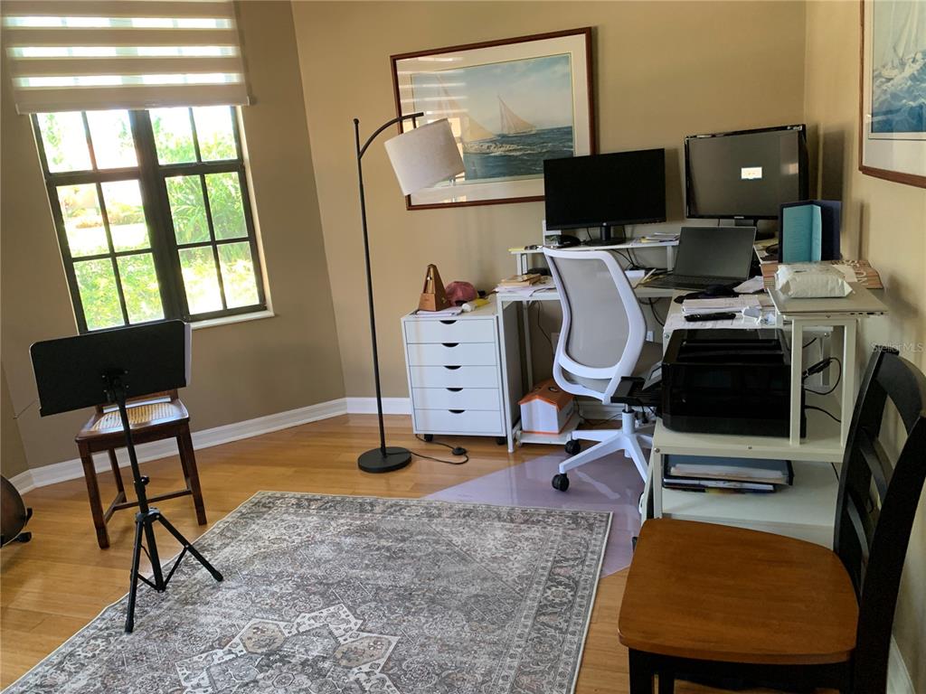 6828 Honeysuckle Trail Lakewood Ranch, FL 34202 - Photo 21 of 36 a view of a workspace with furniture and a window