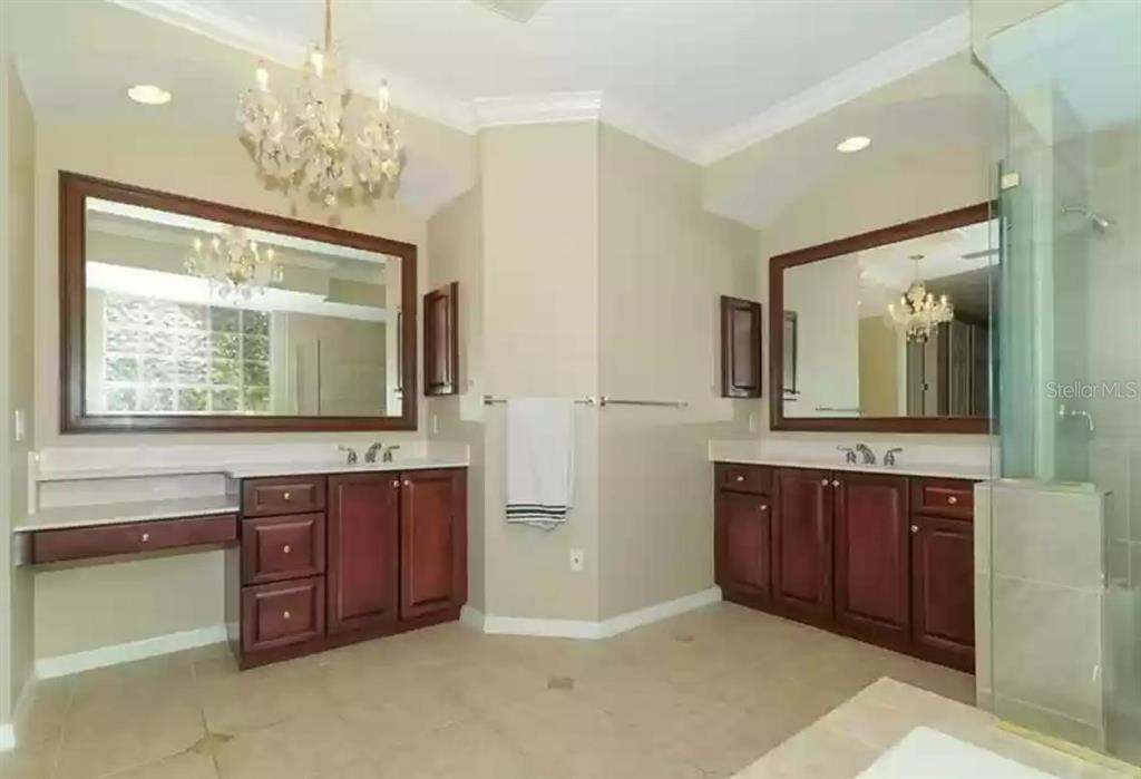 6828 Honeysuckle Trail Lakewood Ranch, FL 34202 - Photo 23 of 36 a bathroom with a sink double vanity granite and a large mirror