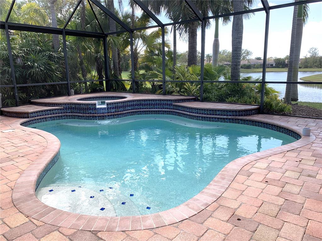 6828 Honeysuckle Trail Lakewood Ranch, FL 34202 - Photo 3 of 36 a view of a swimming pool with a porch