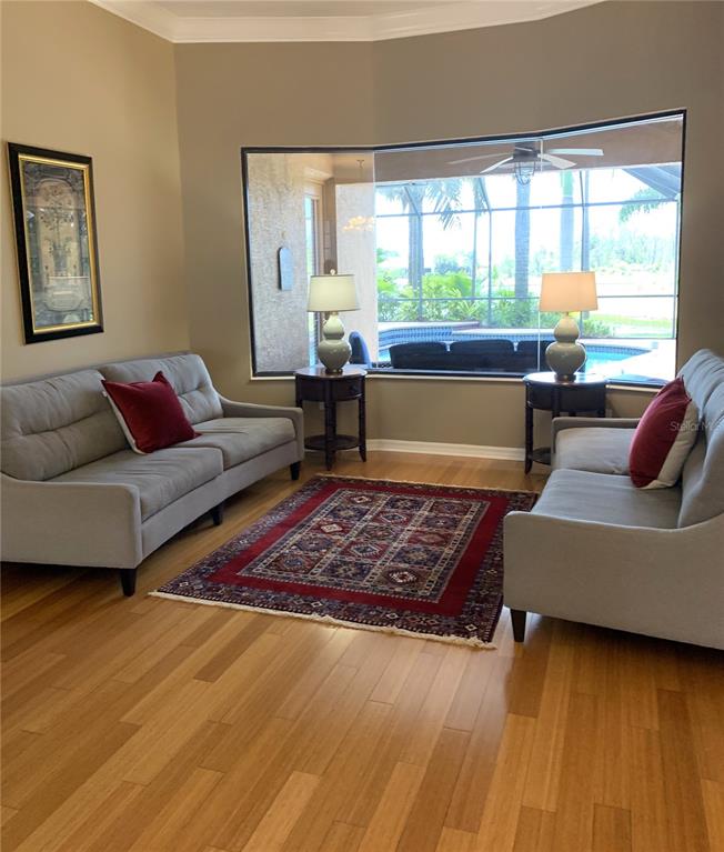 6828 Honeysuckle Trail Lakewood Ranch, FL 34202 - Photo 8 of 36 a living room with furniture and a large window