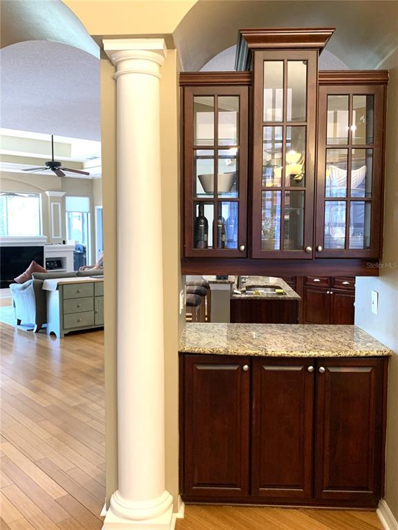 6828 Honeysuckle Trail Lakewood Ranch, FL 34202 - Photo 10 of 36 a view of a kitchen with granite countertop a sink and a stove top oven