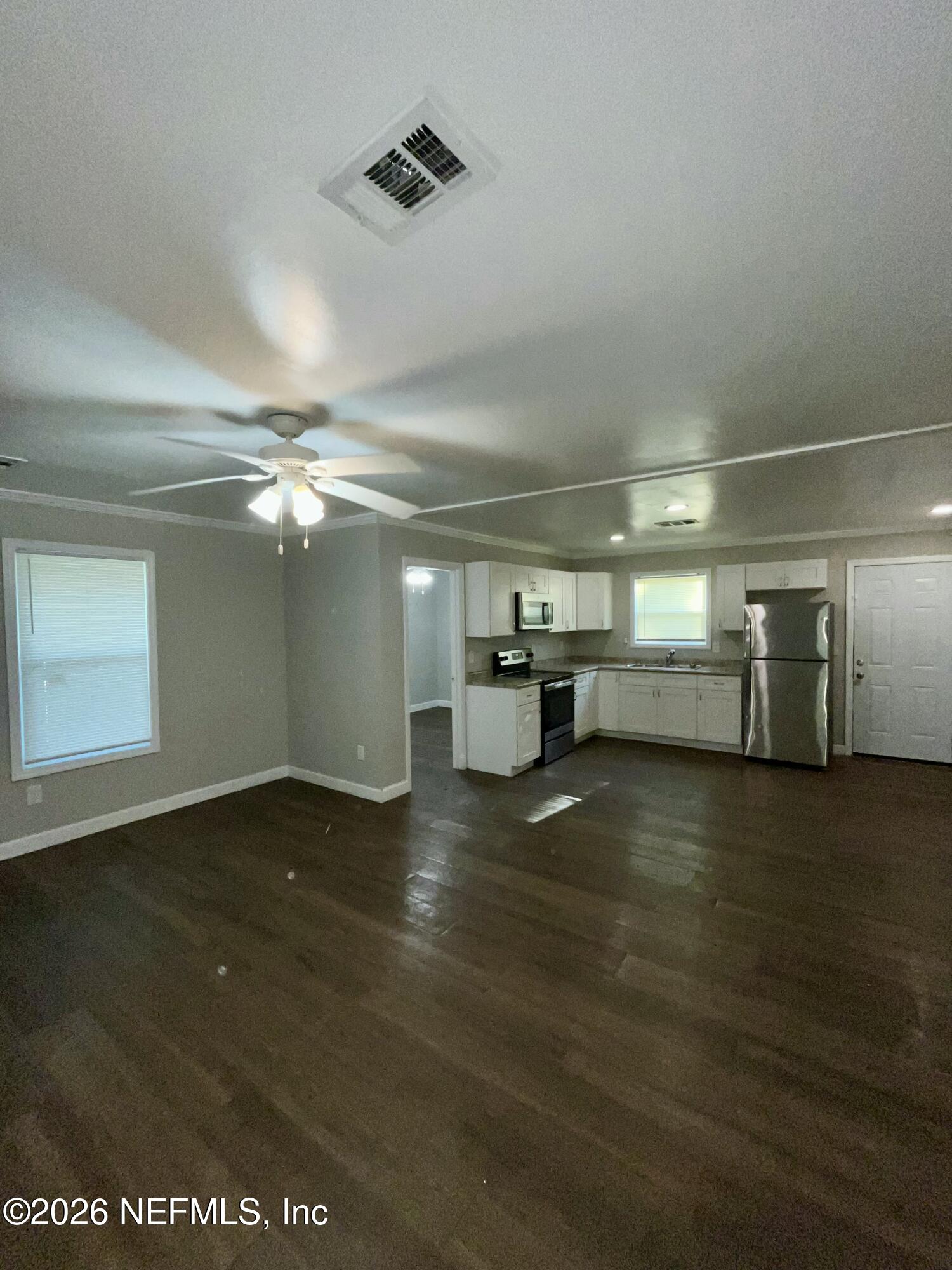 2017 Talladega Road Jacksonville, FL 32209 - Photo 16 of 34 an empty room with wooden floor door and windows