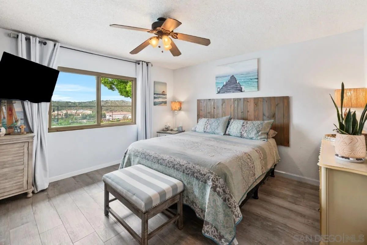 10952 Avenida Roberta Spring Valley, CA 91978 - Photo 15 of 35 a bedroom with a bed a flat screen tv and a large window with the outer view