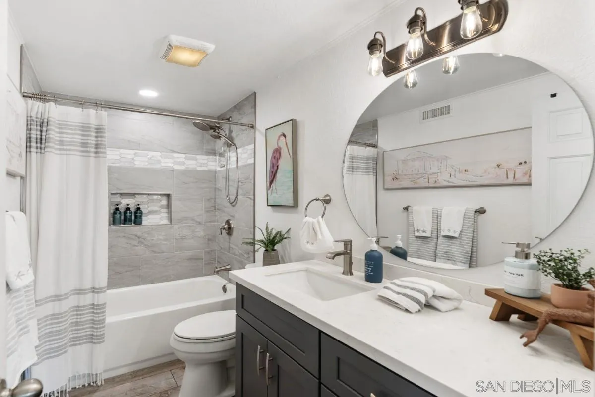 10952 Avenida Roberta Spring Valley, CA 91978 - Photo 20 of 35 a bathroom with a double vanity sink toilet mirror and bathtub