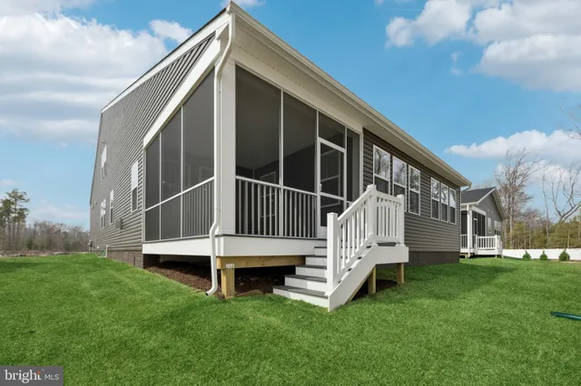 a view of house with a yard