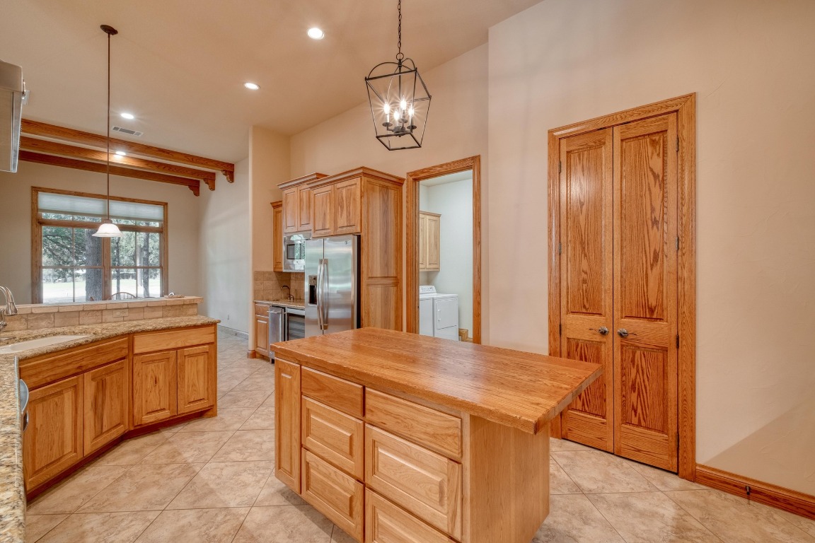 205 Flint Ridge Trail Georgetown, TX 78628 - Photo 15 of 40 a kitchen with stainless steel appliances granite countertop a stove and a refrigerator