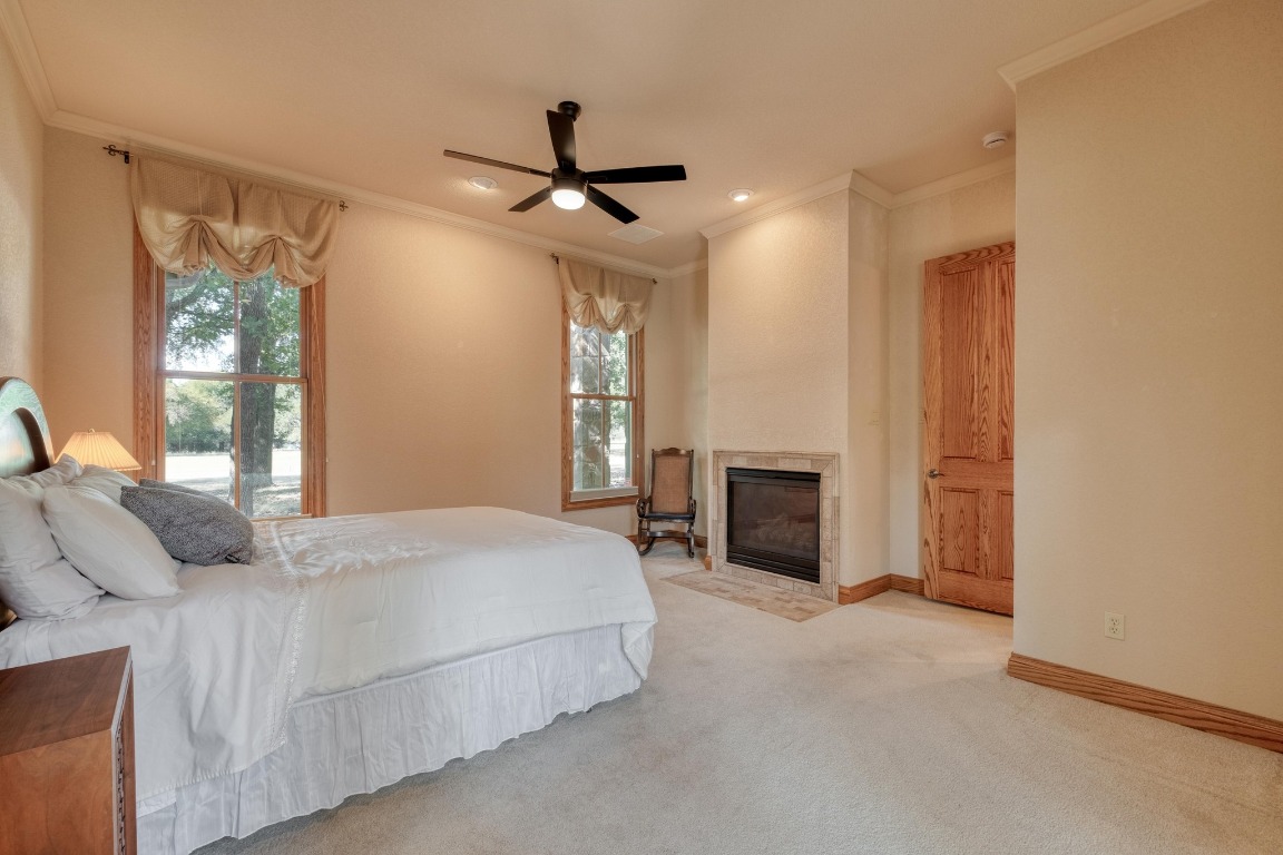 205 Flint Ridge Trail Georgetown, TX 78628 - Photo 20 of 40 a bedroom with a bed and a fireplace