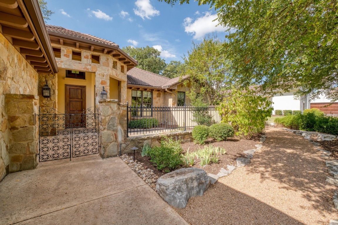 205 Flint Ridge Trail Georgetown, TX 78628 - Photo 2 of 40 a view of a large building with large tree and plants